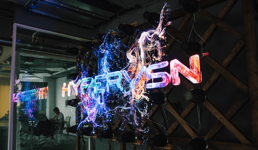 Holographic fan displaying a floating brand graphic